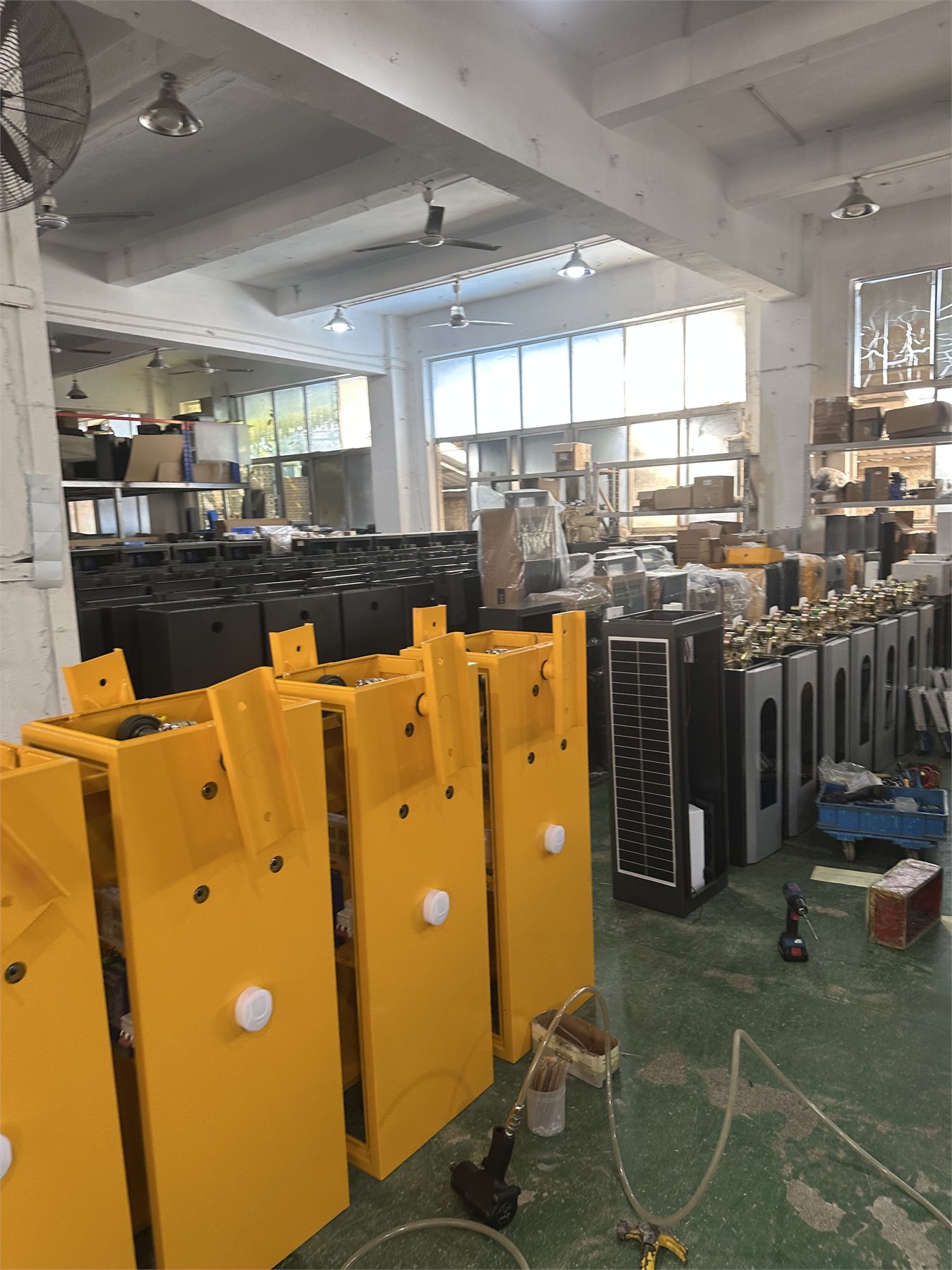 Vehicle gate barrier cabinets arranged on a production floor